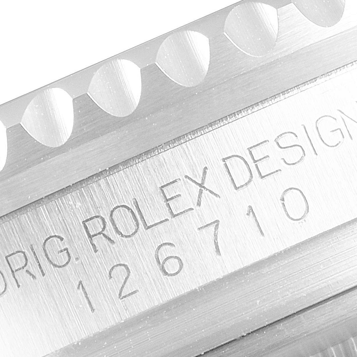 This close-up image shows the reference number and part of the bezel of a Rolex GMT-Master 126710 Men
s Stainless Steel Black Dial 126710 Men
s Stainless Steel Black Dial watch.