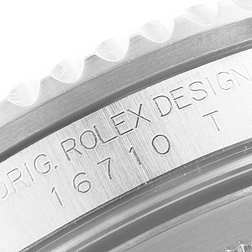 This image shows a close-up of the engraved case side of a Rolex GMT-Master 16710 Men
s Stainless Steel Black Dial 16710 Men
s Stainless Steel Black Dial model 16710.