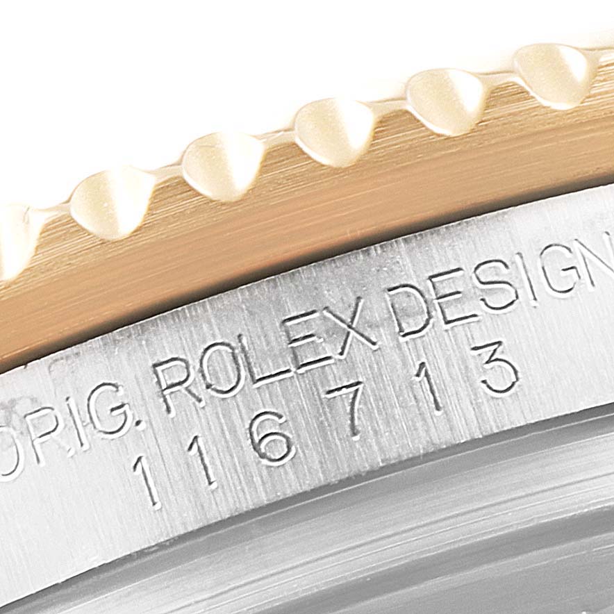 Close-up of the bezel and case side of a Rolex GMT-Master 116713 Men's Steel and Gold (two tone) Black Dial 116713 Men's Steel and Gold (two tone) Black Dial, showing the model number 116713.