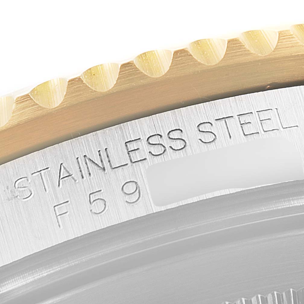 This image shows the engraved caseback edge and part of the bezel of a Rolex GMT-Master 16713 Men's Steel and Gold (two tone) Black Dial 16713 Men's Steel and Gold (two tone) Black Dial watch.