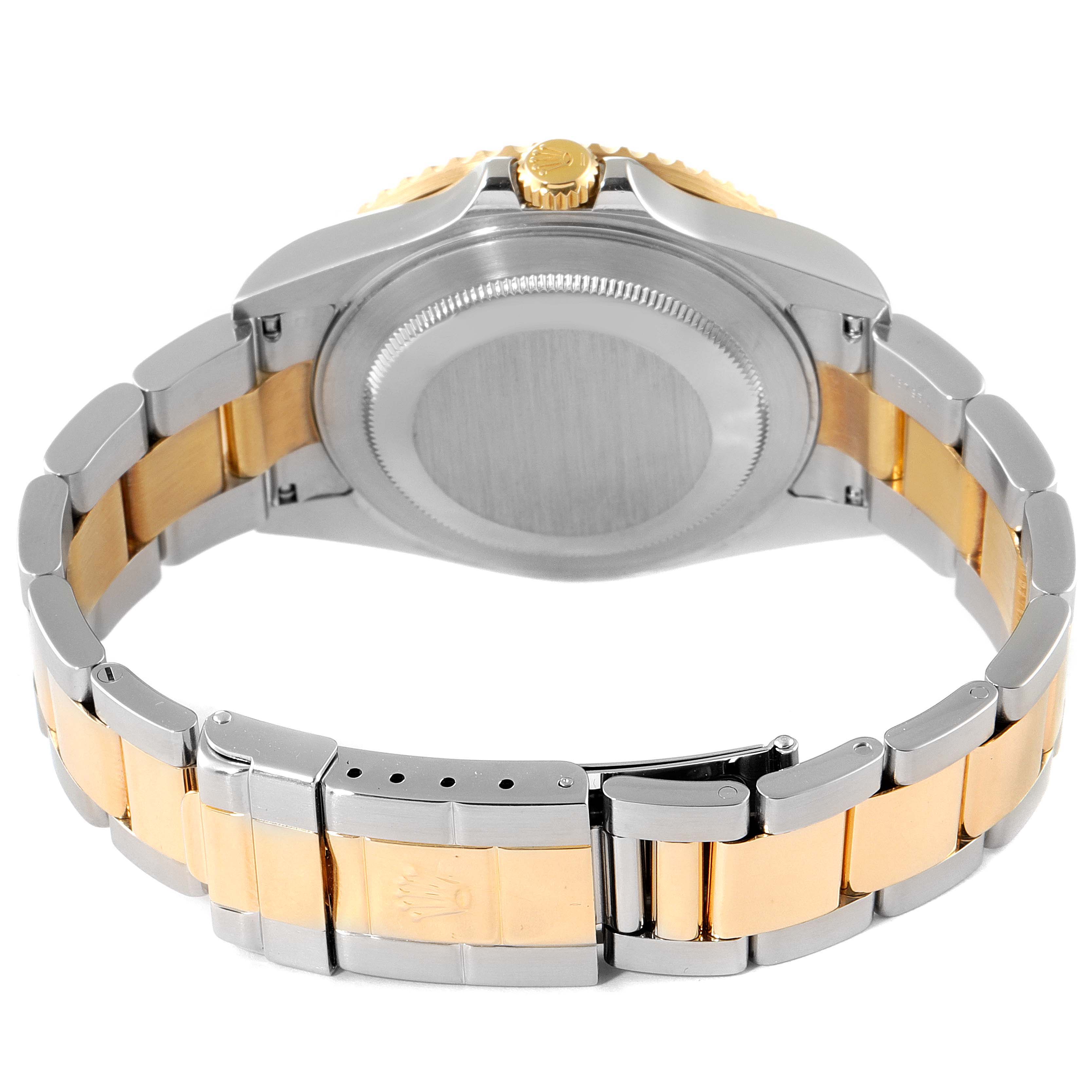 The image shows the back of the Rolex GMT-Master 16713 Men's Steel and Gold (two tone) Black Dial 16713 Men's Steel and Gold (two tone) Black Dial watch, focusing on the case back and the two-tone bracelet.