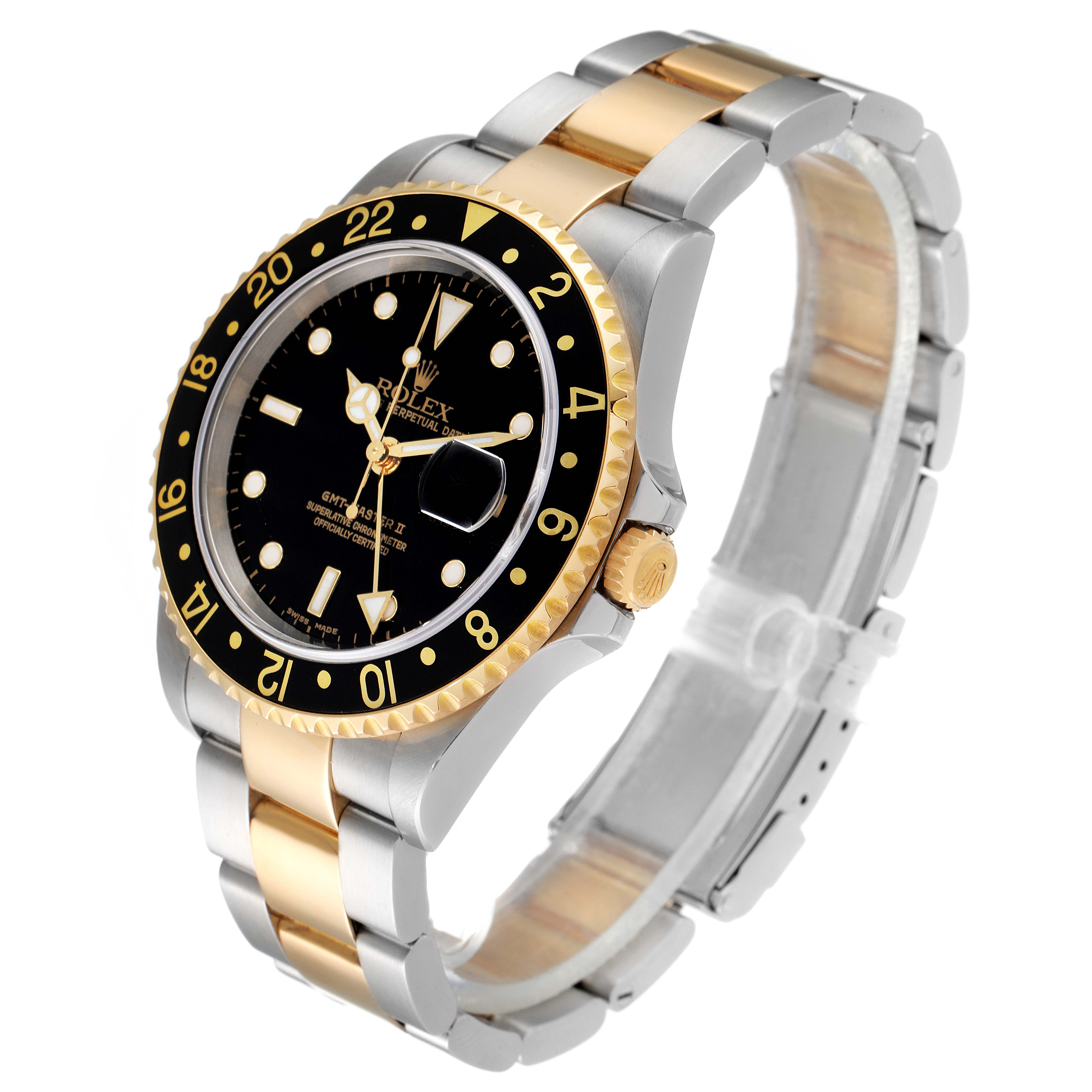 The image shows a Rolex GMT-Master 16713 Men's Steel and Gold (two tone) Black Dial 16713 Men's Steel and Gold (two tone) Black Dial watch at a three-quarter angle, highlighting the black dial, two-tone bezel, and bracelet.