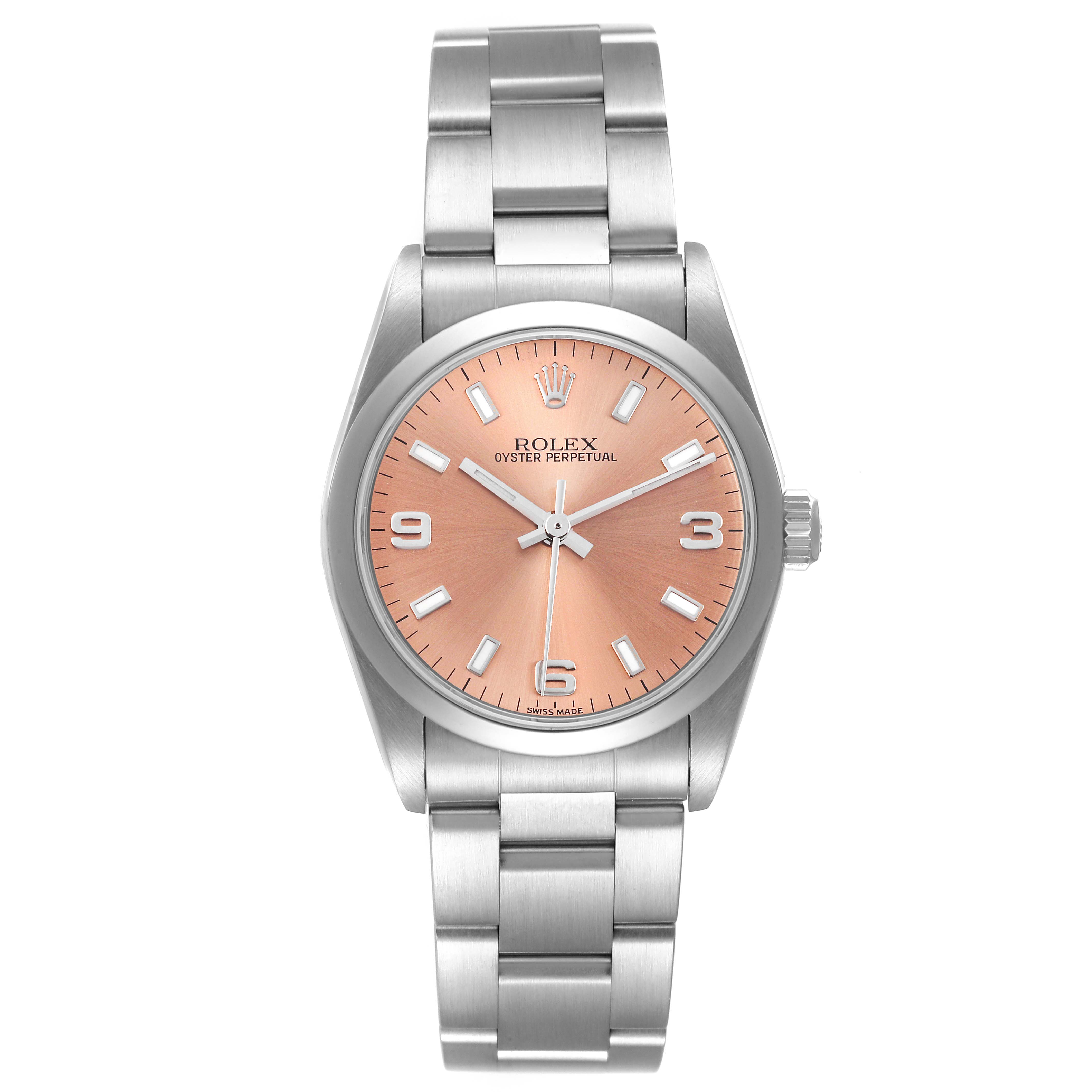 The image shows a front view of a Rolex Mid-Size 77080 Women
s Stainless Steel Pink Dial 77080 Women
s Stainless Steel Pink Dial Oyster Perpetual watch with a salmon-colored dial and a stainless steel bracelet.
