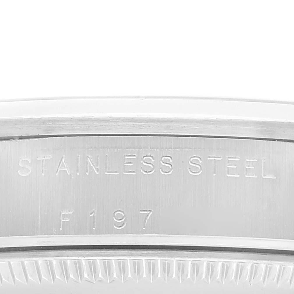 The image shows a close-up of the back of a Mid-Size Rolex watch case, highlighting the "STAINLESS STEEL" engraving.