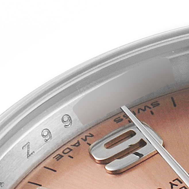 The image shows a close-up of the dial and bezel of a Rolex Oyster Perpetual 176200 Women's Stainless Steel Pink Dial 176200 Women's Stainless Steel Pink Dial watch, highlighting the numerals and part of the minute hand.