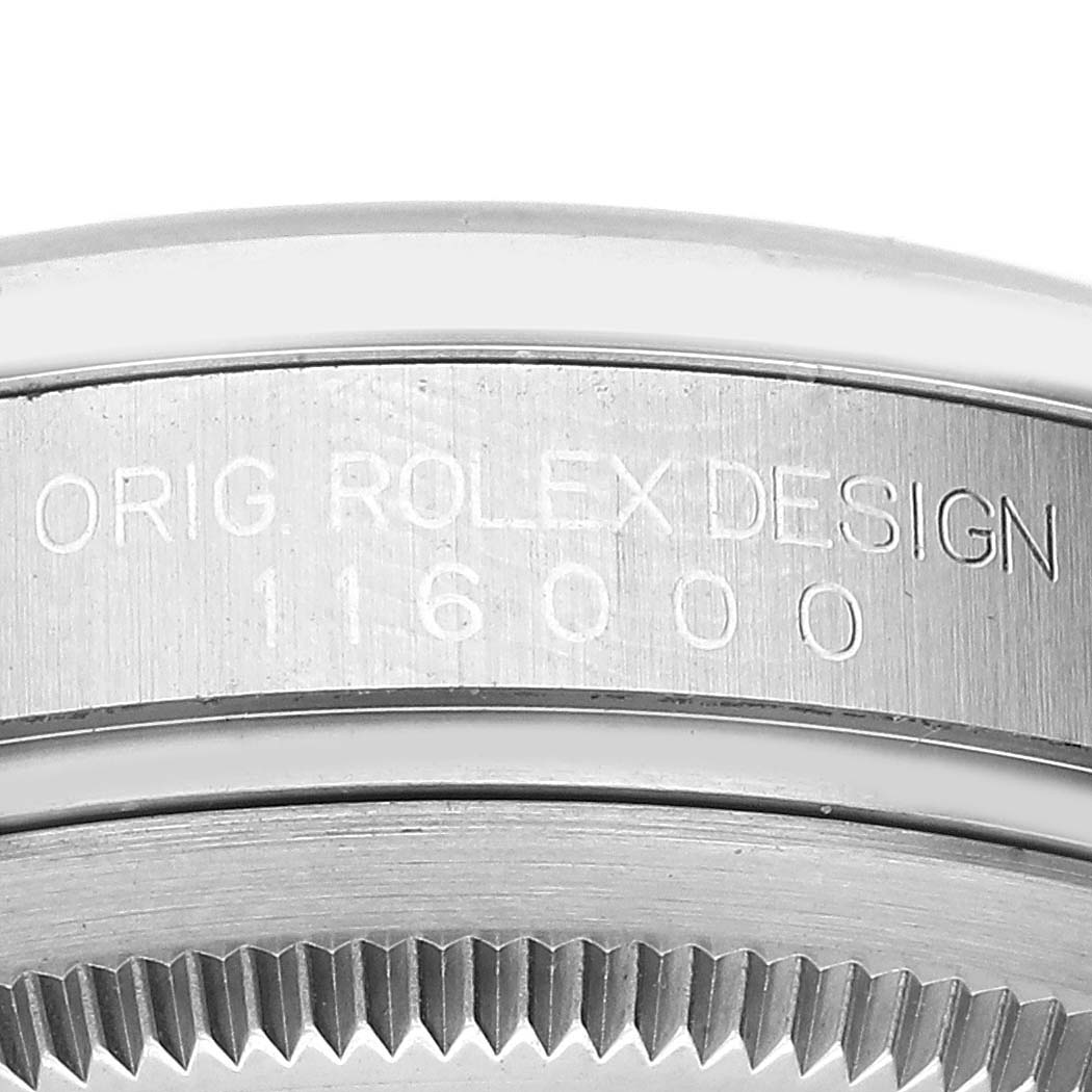 The image shows a close-up of the case back and serial number of a Rolex Oyster Perpetual 116000 Men
s Stainless Steel Black Dial 116000 Men
s Stainless Steel Black Dial watch.