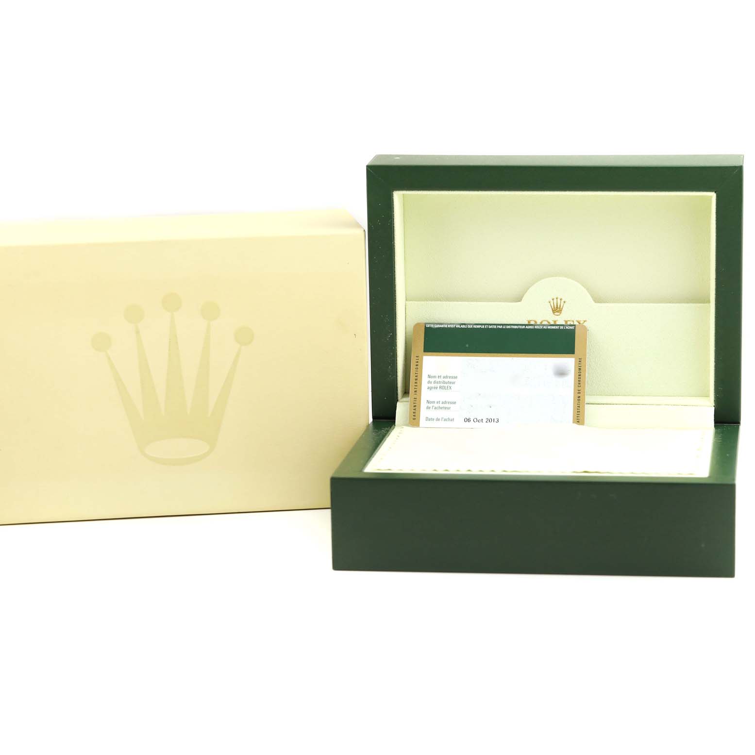 The image shows the packaging and accessories for a Rolex Oyster Perpetual 116000 Men
s Stainless Steel Black Dial 116000 Men
s Stainless Steel Black Dial model, including the box and warranty card.