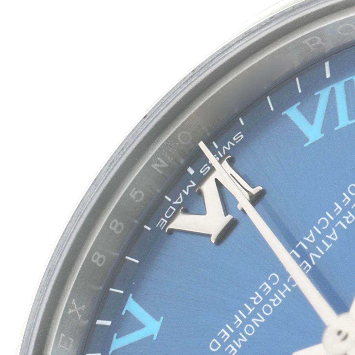 The image shows a close-up of the Rolex Mid-Size 177200 Women
s Stainless Steel Blue Dial 177200 Women
s Stainless Steel Blue Dial watch face, focusing on the "VI" hour marker and part of the minute and hour hands.