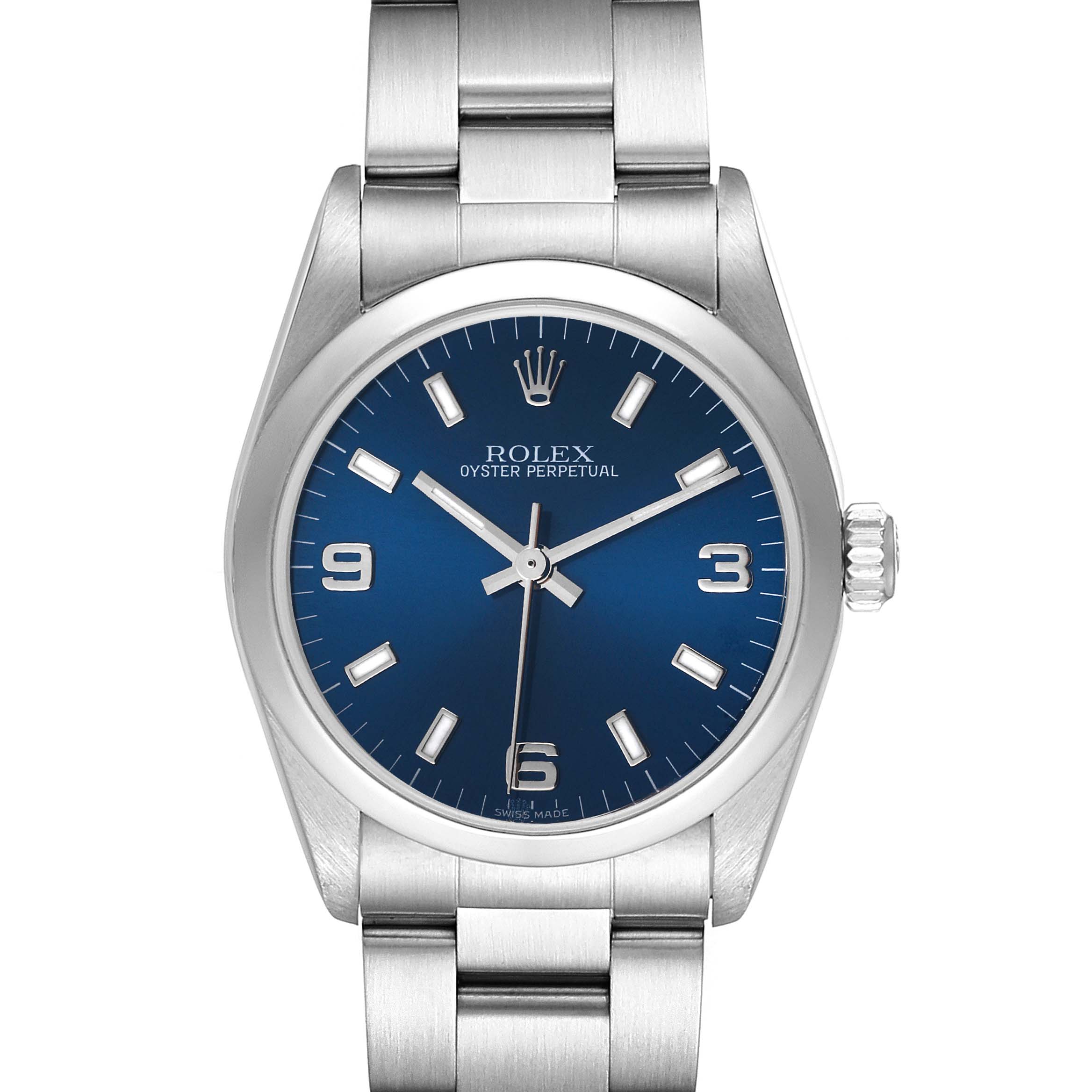 The image shows a front view of a Rolex Oyster Perpetual Mid-Size watch with a blue dial and silver bracelet.