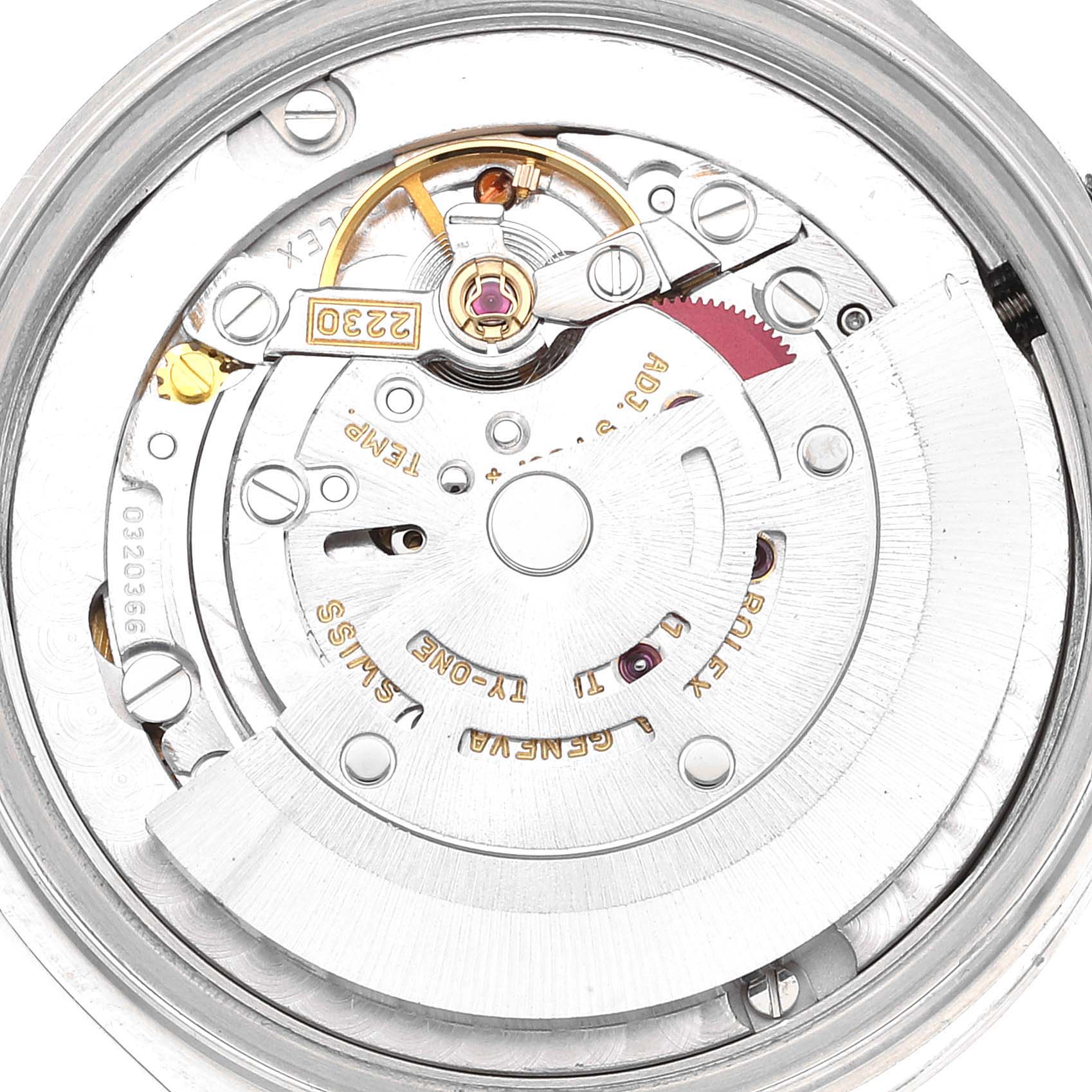 The image shows a close-up, top-down view of the internal mechanism of a Rolex Mid-Size 77080 Women
s Stainless Steel Blue Dial 77080 Women
s Stainless Steel Blue Dial watch, highlighting its movement and components.