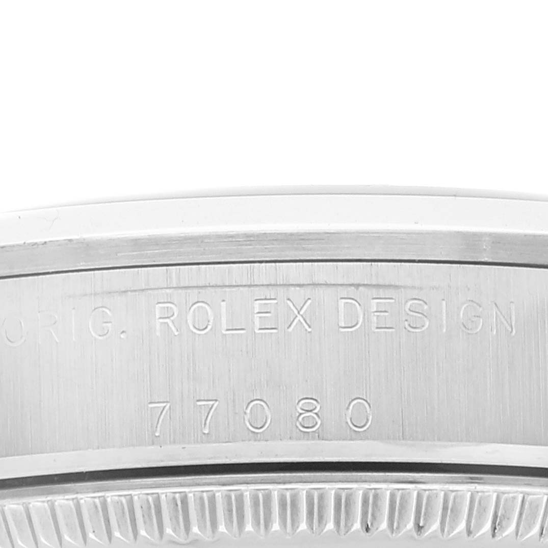 The image shows a close-up of the side of a Mid-Size Rolex watch case, displaying the engraved text "ORIG. ROLEX DESIGN 77080".