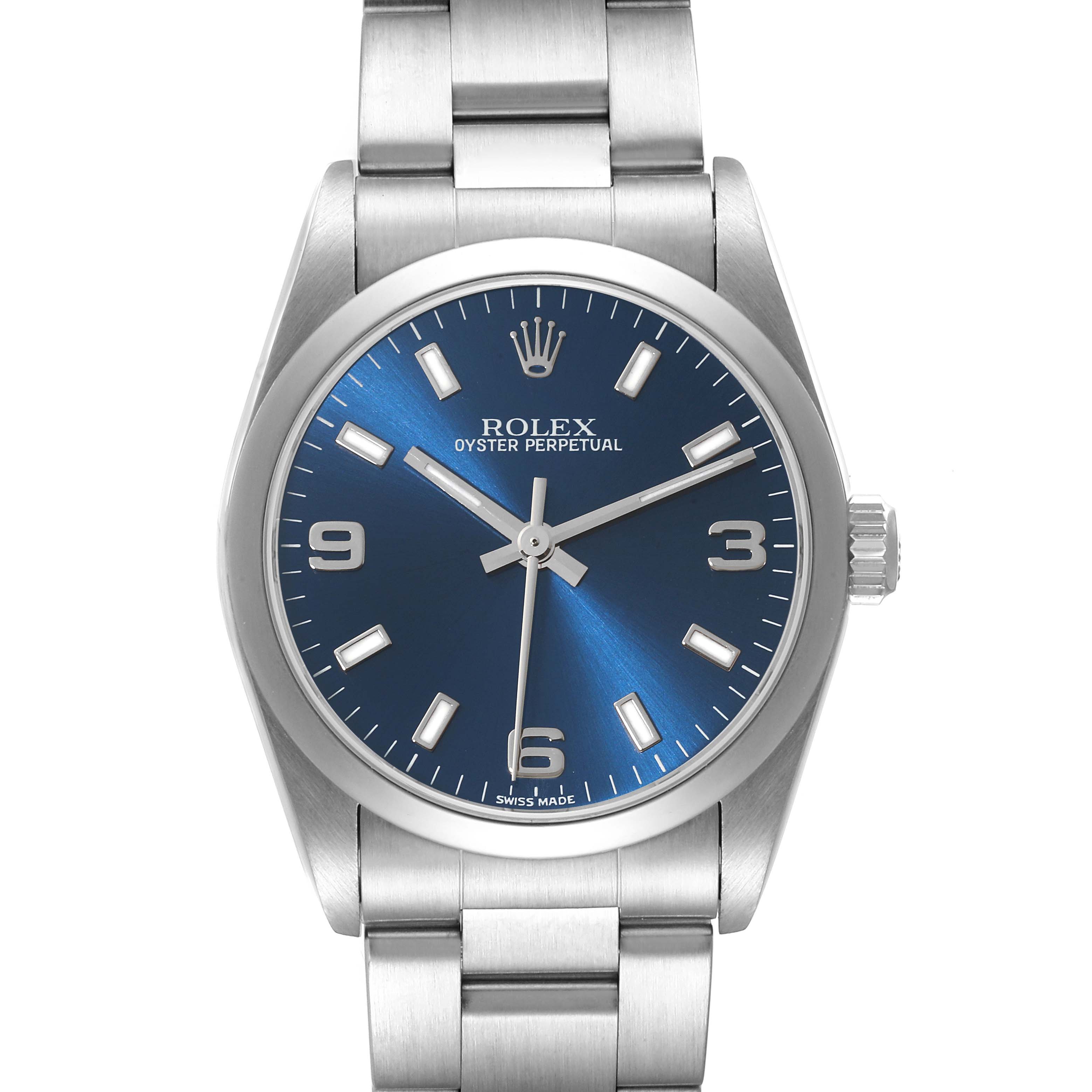 The image shows a front view of a Rolex Oyster Perpetual Mid-Size watch, highlighting its bracelet, crown, and blue dial.