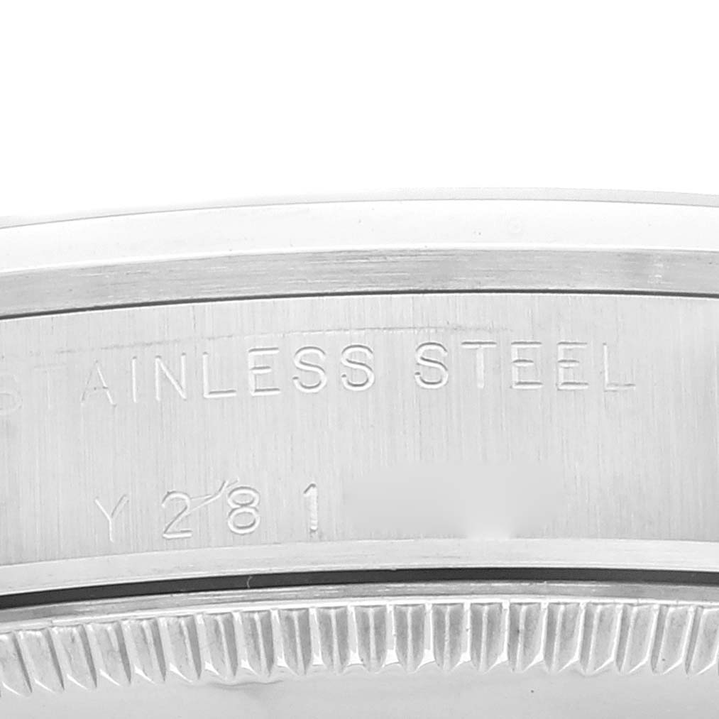 The image shows a close-up of the stainless steel case back with engraved details of a Mid-Size Rolex watch.