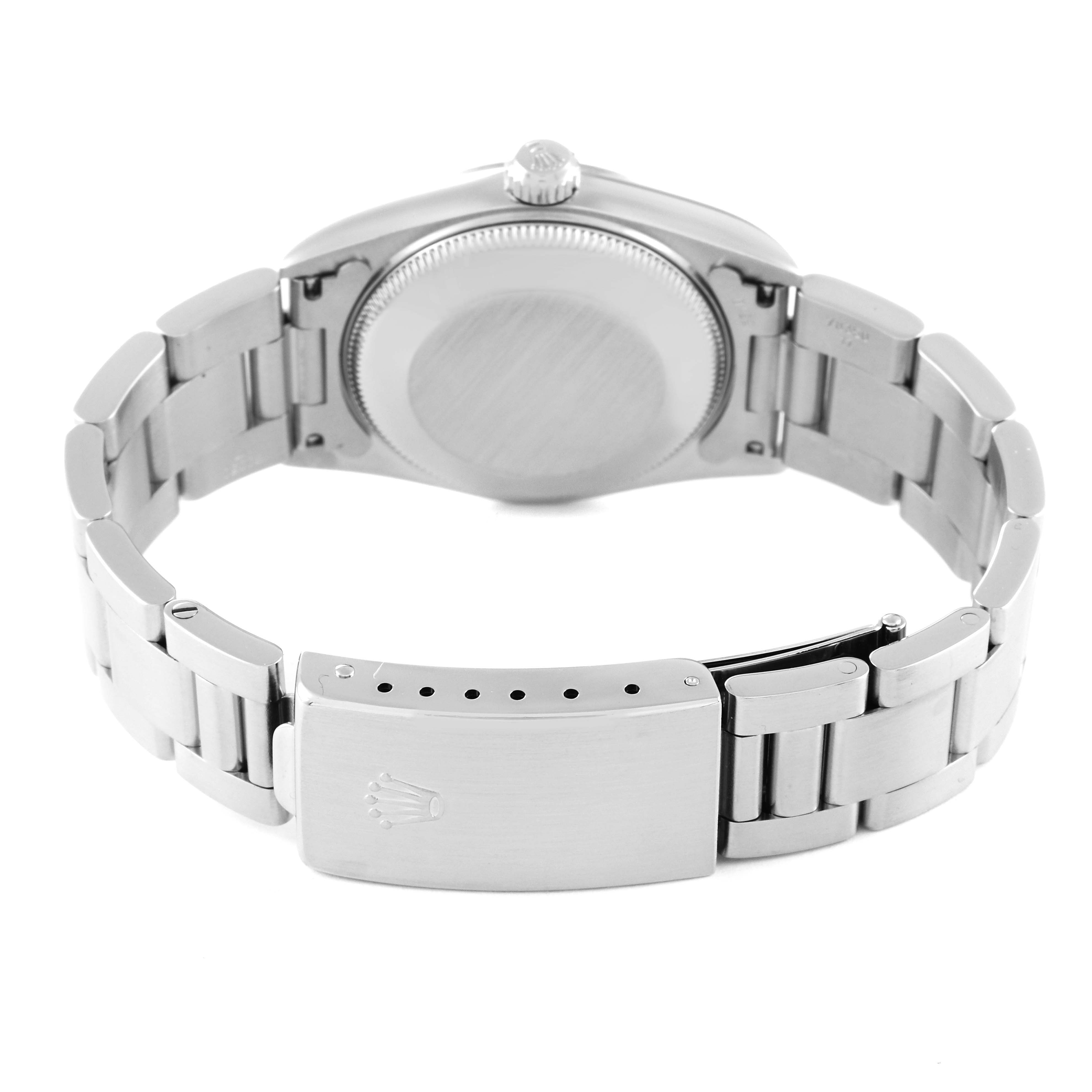 The image shows the back case, crown, and bracelet clasp of a mid-size Rolex watch.