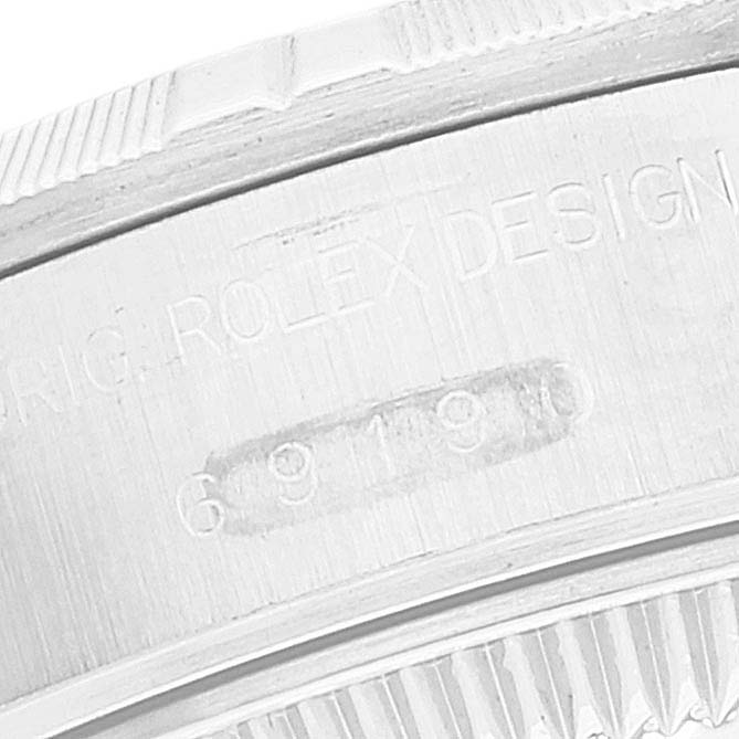 This image shows a close-up of the model number and logo engraving on the side of a Rolex Date 69190 Women's Stainless Steel Blue Dial 69190 Women's Stainless Steel Blue Dial watch.