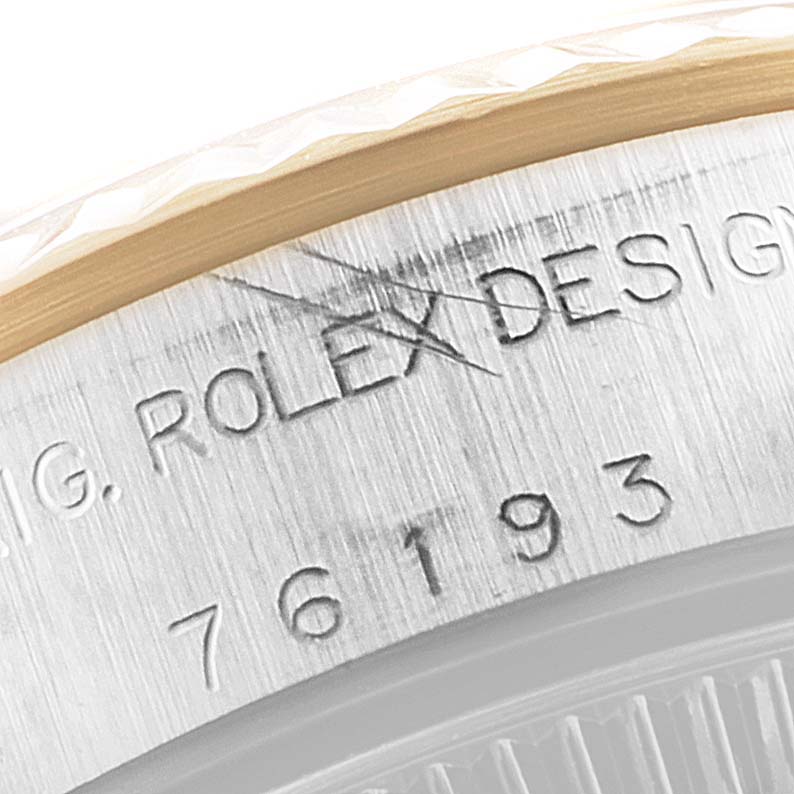 This image shows a close-up of the engraving on the side of a Rolex Oyster Perpetual 76193 Women's Steel and Gold (two tone) Champagne Dial 76193 Women's Steel and Gold (two tone) Champagne Dial watch.