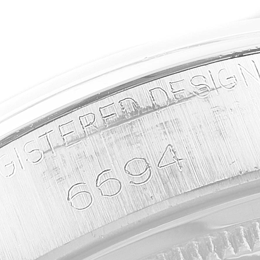 Close-up angle shows the serial number and "REGISTERED DESIGN" engraving on the Rolex Vintage Collection 6694 Men's Stainless Steel Black Dial 6694 Men's Stainless Steel Black Dial model.