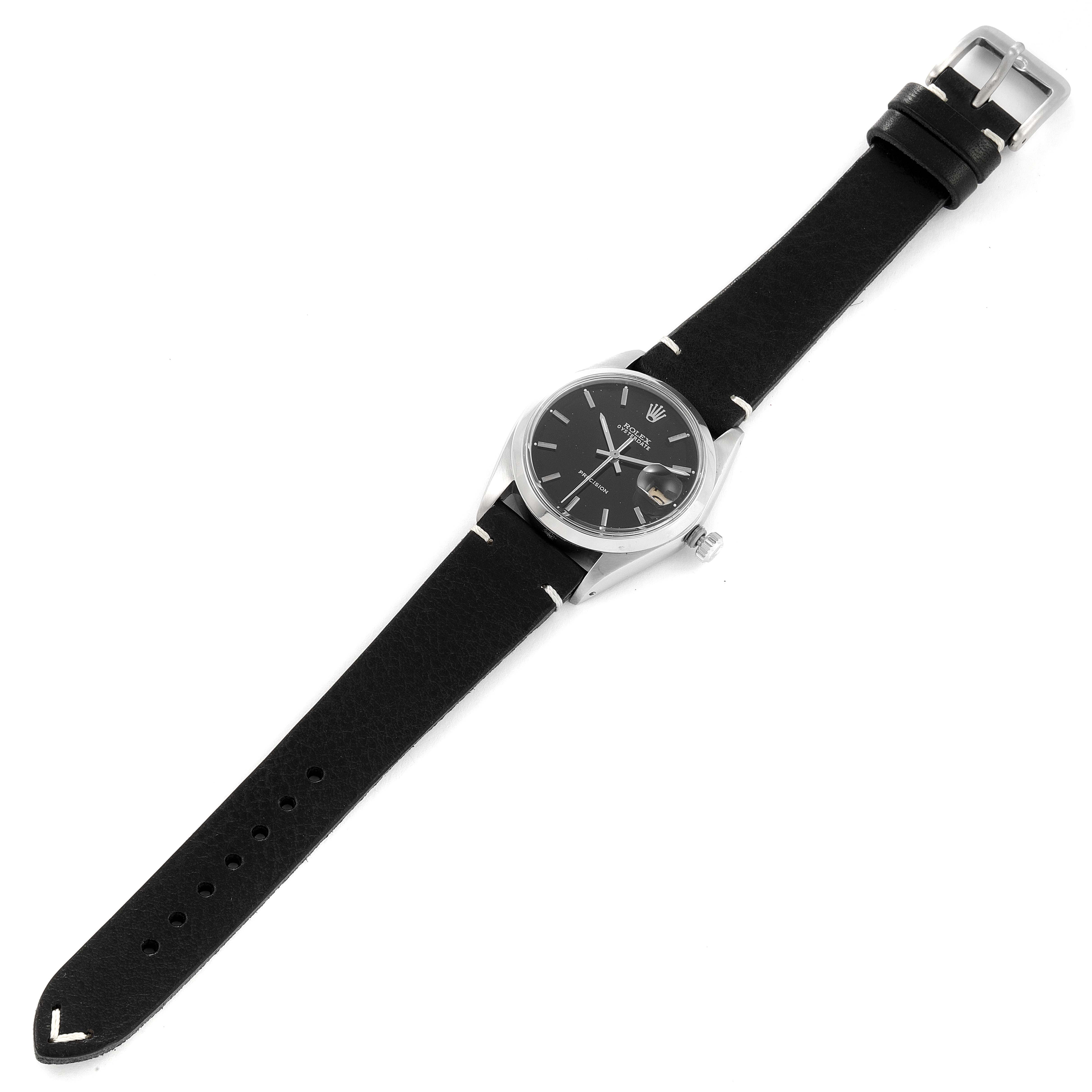 The Rolex Vintage Collection 6694 Men's Stainless Steel Black Dial 6694 Men's Stainless Steel Black Dial watch is shown from an angled view, displaying the face, black leather strap, buckle, and case.