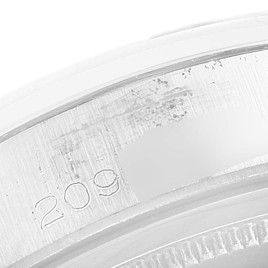 The image shows a close-up of the rim and serial number engraving on a Rolex Vintage Collection 6694 Men's Stainless Steel Black Dial 6694 Men's Stainless Steel Black Dial watch.