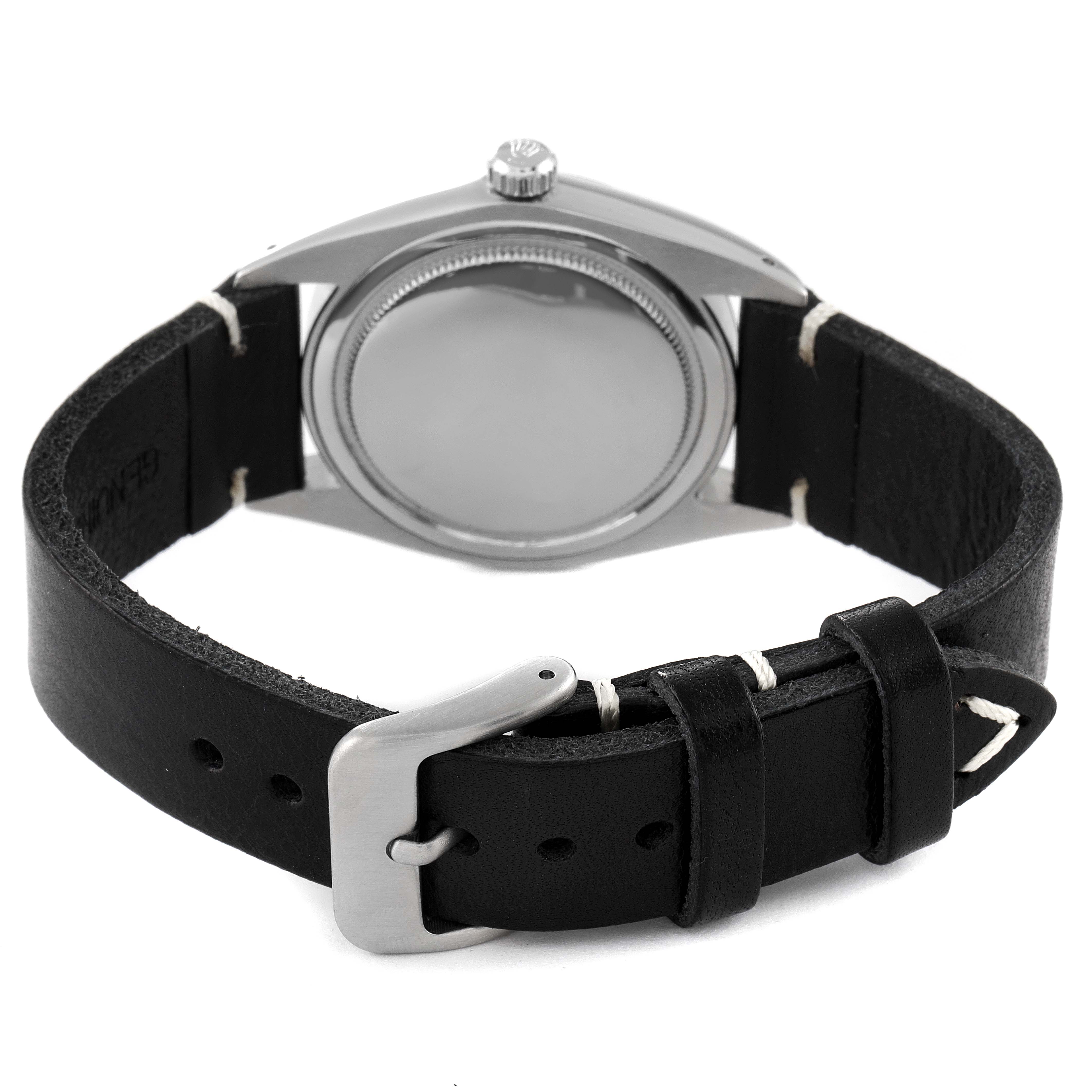 The image shows the back view of a Rolex Vintage Collection 6694 Men's Stainless Steel Black Dial 6694 Men's Stainless Steel Black Dial watch with a black leather strap and a buckle.