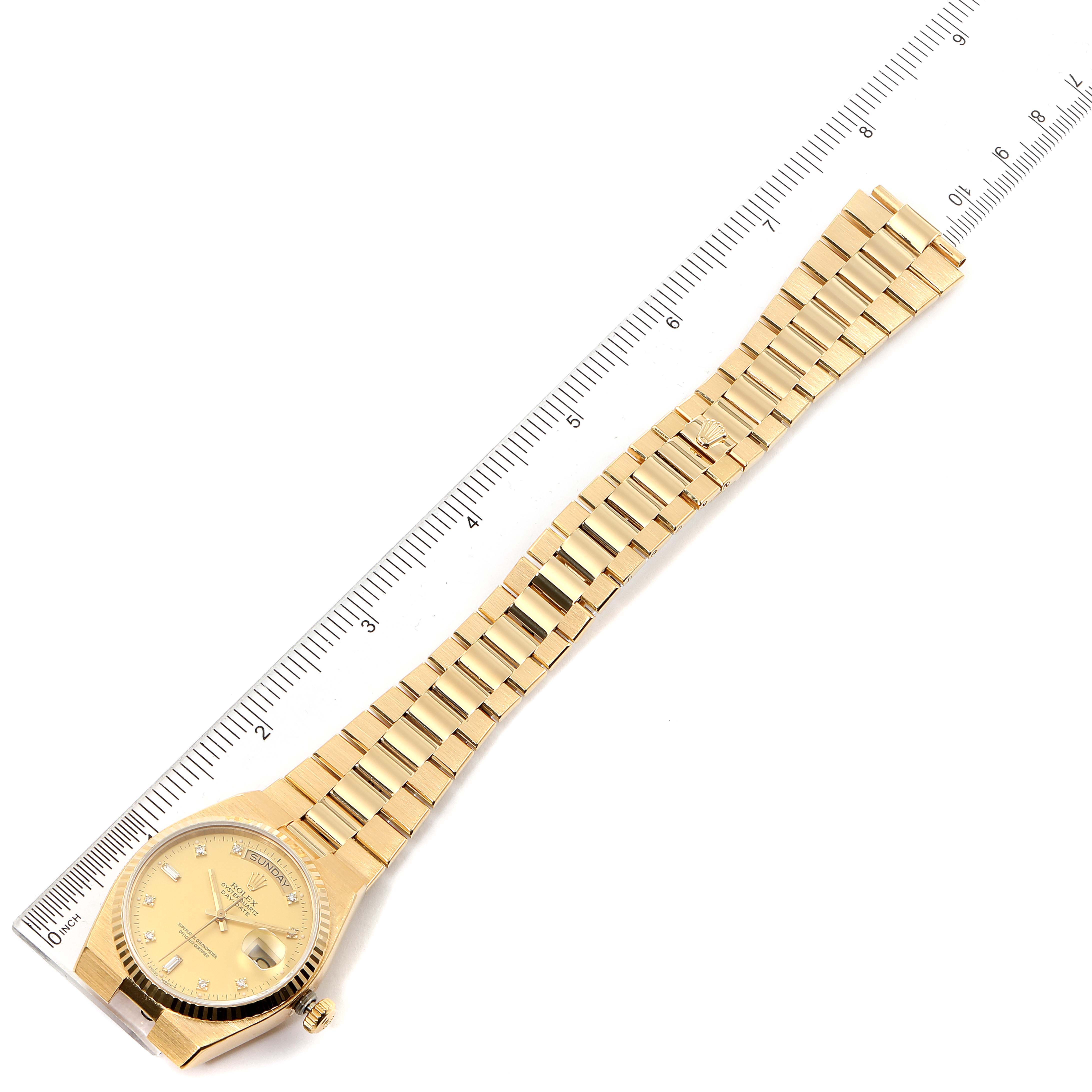 The Rolex President 19018 Men
s Yellow Gold Champagne Dial 19018 Men
s Yellow Gold Champagne Dial model watch is shown flat with the face and full length of the bracelet displayed next to a ruler for scale.