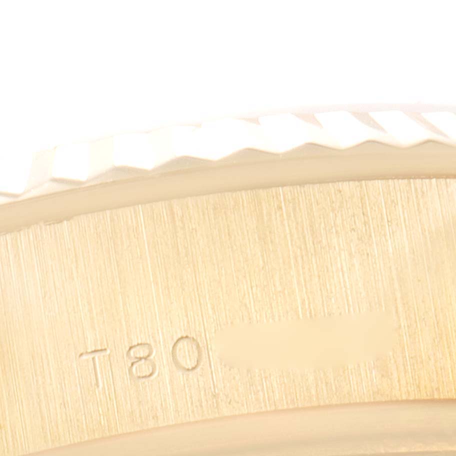 This macro image shows a detailed view of the side edge and engraved number of a Rolex President 69178 Women's Yellow Gold Beige Dial 69178 Women's Yellow Gold Beige Dial watch.