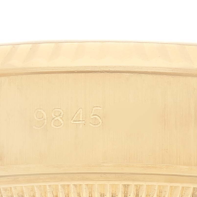 This close-up image shows the side of a Rolex President 69178 Women
s Yellow Gold Champagne Dial 69178 Women
s Yellow Gold Champagne Dial model
s casing, highlighting engraved numbers and bezel details.
