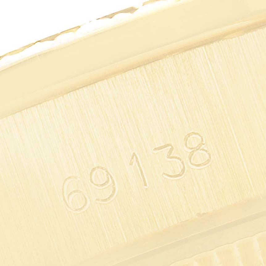 This close-up image shows the model number engraving on the case of a Rolex President 69138 Women
s Yellow Gold Champagne Dial 69138 Women
s Yellow Gold Champagne Dial watch.