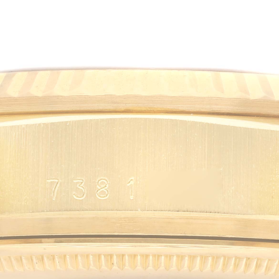 This image shows a close-up of the side casing and part of the engraved serial number of the Rolex President 18038 Men
s Yellow Gold White Dial 18038 Men
s Yellow Gold White Dial model watch.