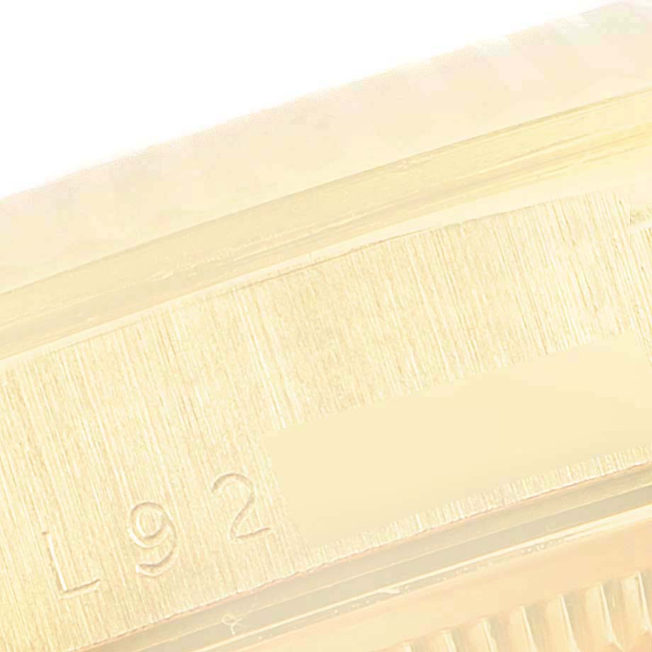 This close-up image of a Rolex President 18238 Men
s Yellow Gold Champagne Dial 18238 Men
s Yellow Gold Champagne Dial model watch shows a detailed view of its case edge with partial serial numbers.