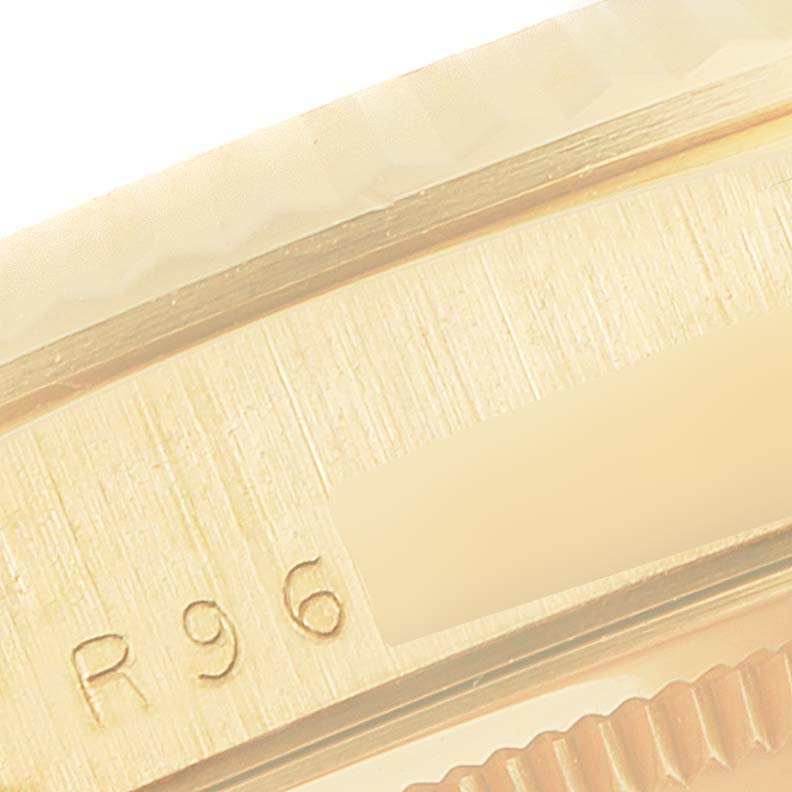 The image shows a close-up of the edge of the case and bezel of a Rolex President 18238 Men
s Yellow Gold Champagne Dial 18238 Men
s Yellow Gold Champagne Dial model watch, featuring part markings.