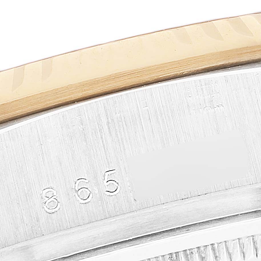 This image shows a close-up of the serial number on the Rolex President 18039B Men's White Gold Brown Dial 18039B Men's White Gold Brown Dial model's caseback and bezel.