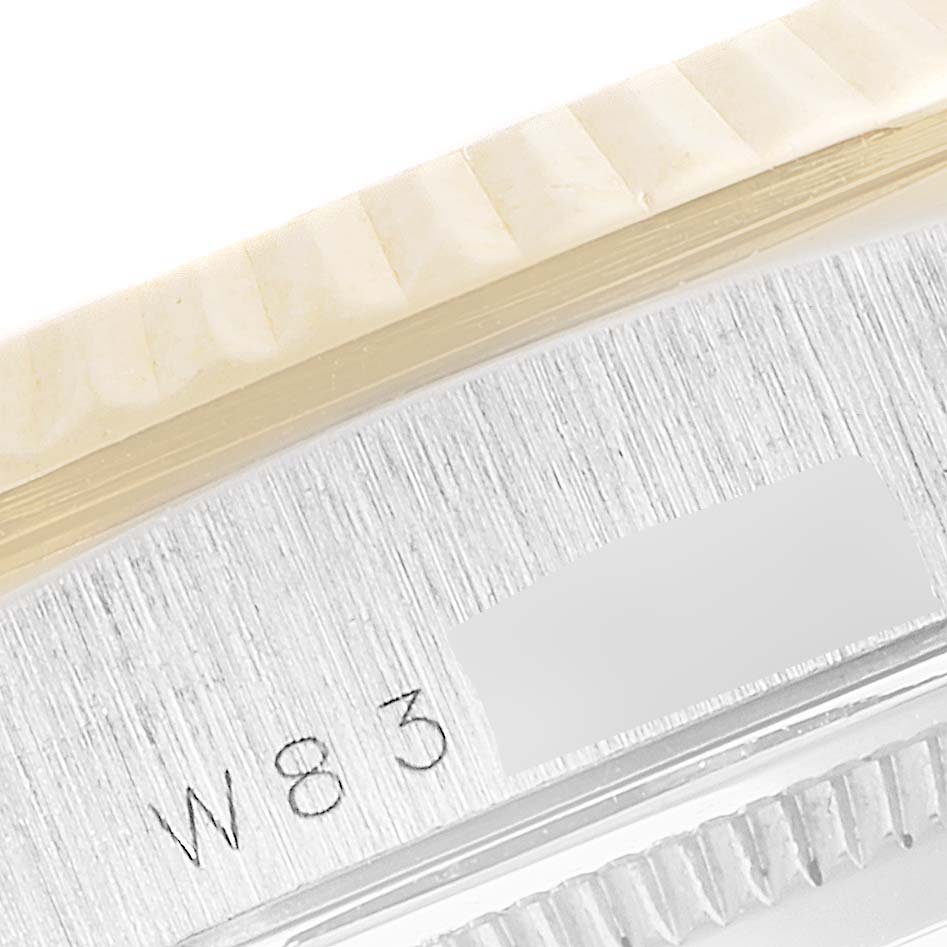 The image shows a close-up of the side of a Rolex President 18239 Men's White Gold Brown Dial 18239 Men's White Gold Brown Dial model watch, featuring part of the fluted bezel and engraved model details.