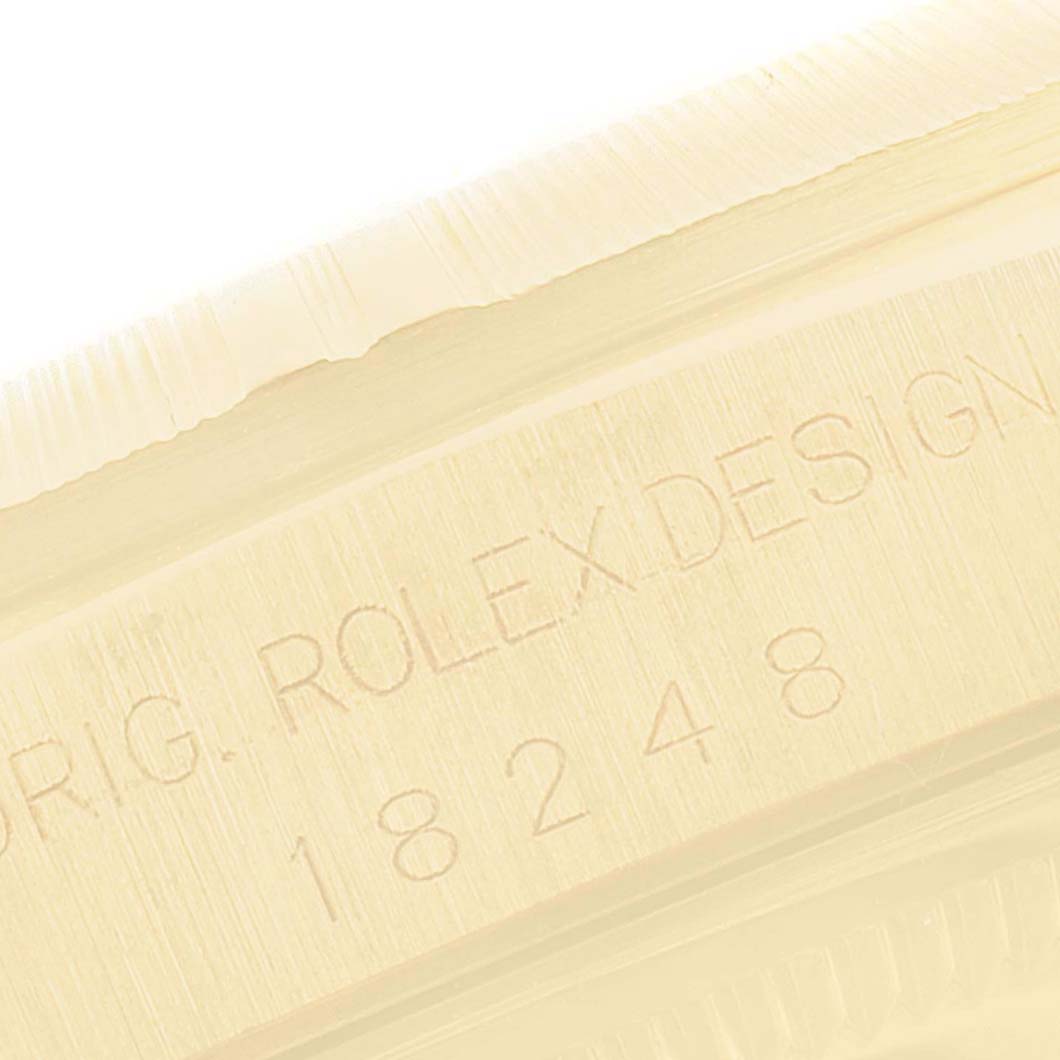 This image shows a close-up of the case side of the Rolex President 18248 Men
s Yellow Gold Champagne Dial 18248 Men
s Yellow Gold Champagne Dial watch, displaying the model number and "ROLEX DESIGN" engraving.