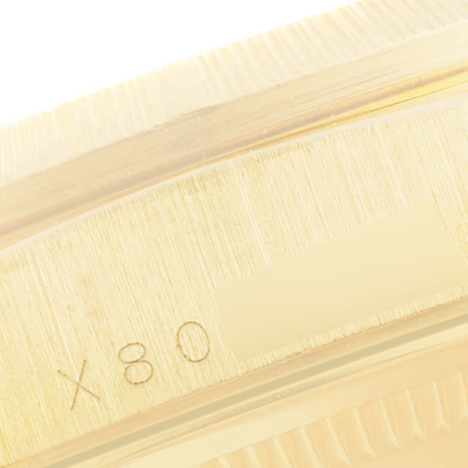 This close-up image shows the side of the bezel and the serial number of a Rolex President 18248 Men
s Yellow Gold Champagne Dial 18248 Men
s Yellow Gold Champagne Dial model watch.