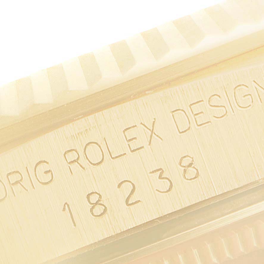 The image shows a close-up of the model number "18238" and the engraving "ORIG ROLEX DESIGN" on a Rolex President 18238 Men
s Yellow Gold Champagne Dial 18238 Men
s Yellow Gold Champagne Dial watch.