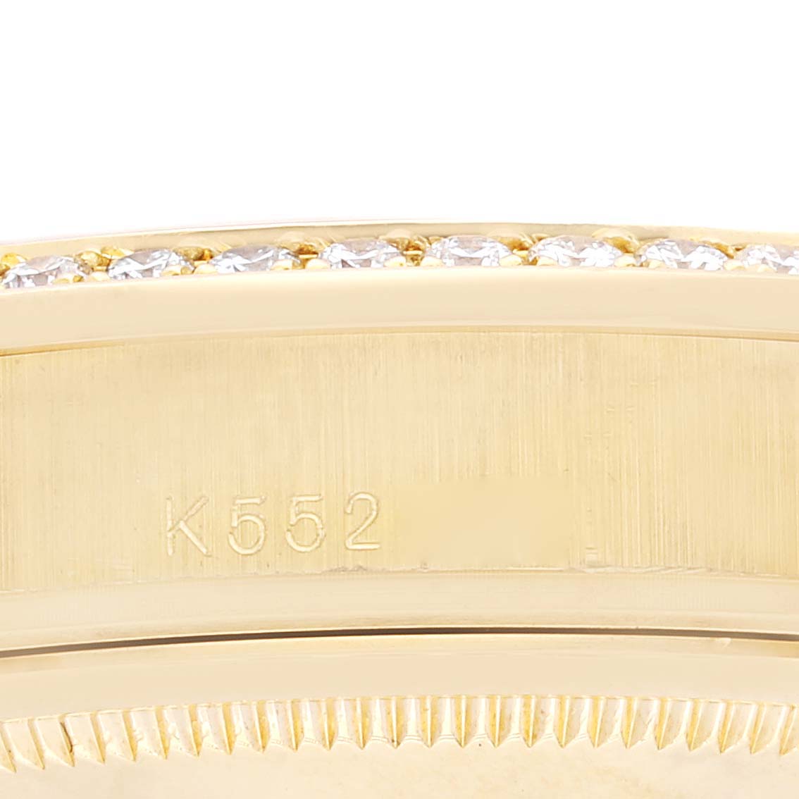 The image shows a close-up of the engraved casing and part of the bezel with diamonds on a Rolex President 118348 Men's Yellow Gold Champagne Dial 118348 Men's Yellow Gold Champagne Dial model.