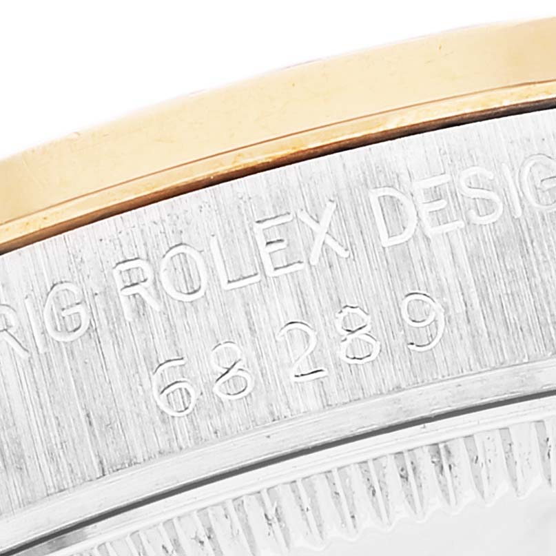 The image shows a close-up view of the engraved bezel edge on a Mid-Size Rolex watch.