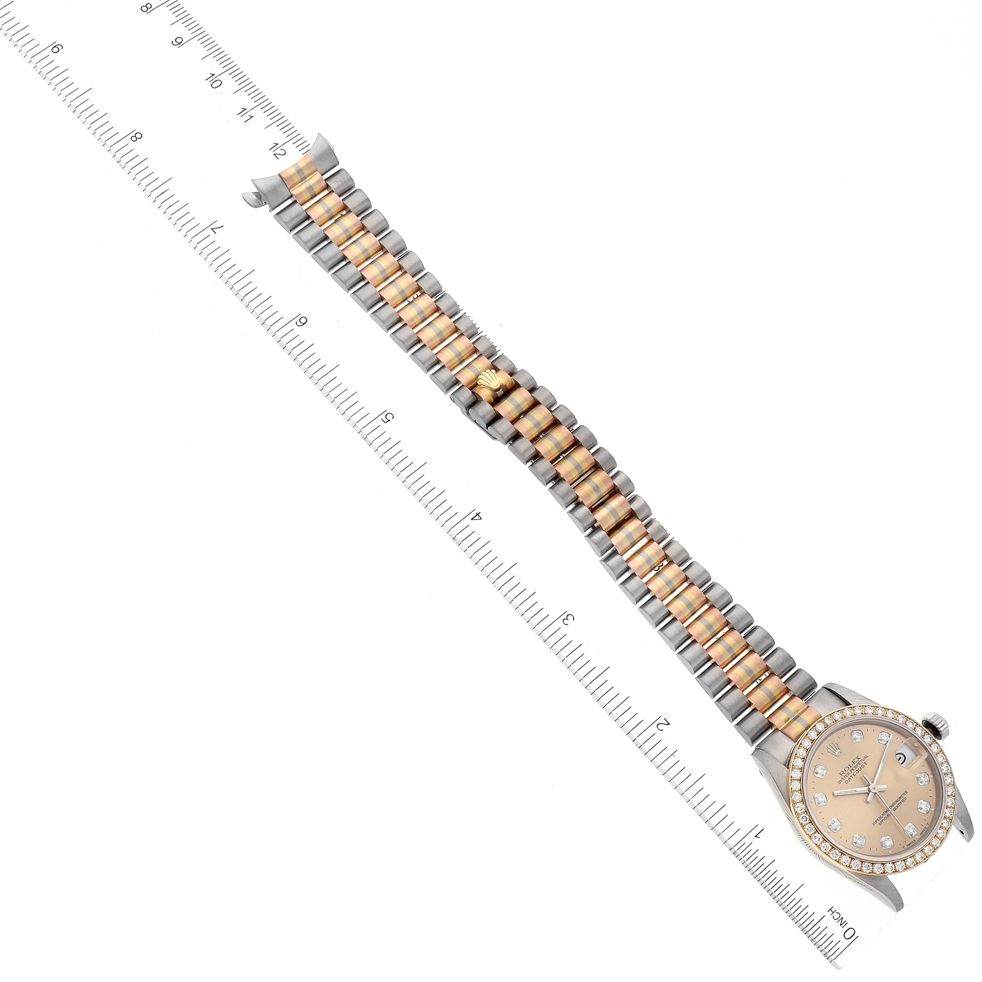 The image shows a Rolex Mid-Size 68289 Women's White Gold Brown Dial 68289 Women's White Gold Brown Dial model watch laid flat with a ruler, showcasing its band and face.