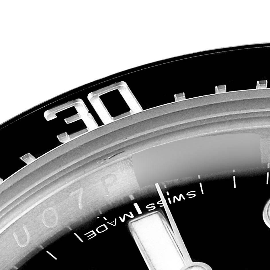 This image shows a close-up of the bezel and part of the dial of a Rolex Sea-Dweller 116600 Men
s Stainless Steel Black Dial 116600 Men
s Stainless Steel Black Dial watch.