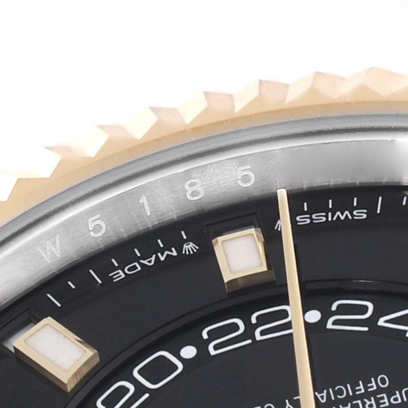 The image shows a close-up of the dial and part of the bezel of a Rolex Sky-Dweller 336933 Men
s Steel and Gold (two tone) Black Dial 336933 Men
s Steel and Gold (two tone) Black Dial watch.