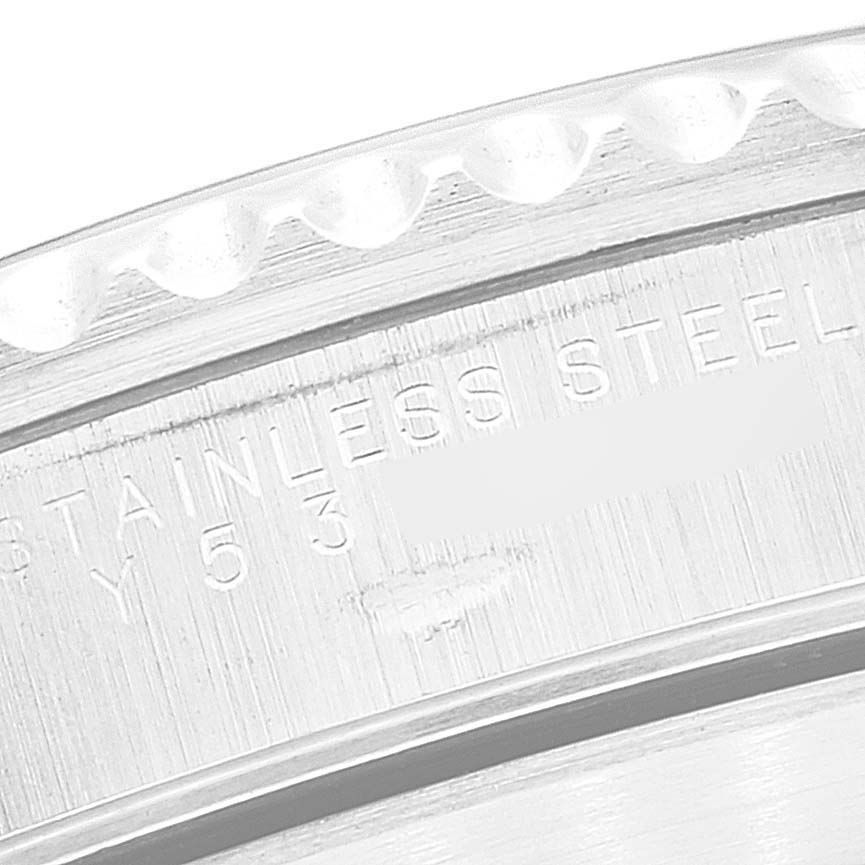 This image shows a close-up of the case back edge and part of the bezel of a Rolex Submariner 14060 Men
s Stainless Steel Black Dial 14060 Men
s Stainless Steel Black Dial watch, highlighting the "Stainless Steel" engraving.