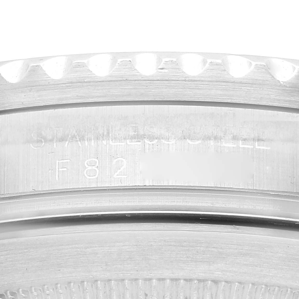 This image shows a close-up of the engraved stainless steel case back and bezel edge of a Rolex Submariner 16610LV Men
s Stainless Steel Black Dial 16610LV Men
s Stainless Steel Black Dial watch.