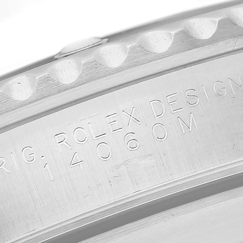 This image shows an angled, close-up view of the engraved bezel and case side of a Rolex Submariner 14060 Men's Stainless Steel Black Dial 14060 Men's Stainless Steel Black Dial watch.