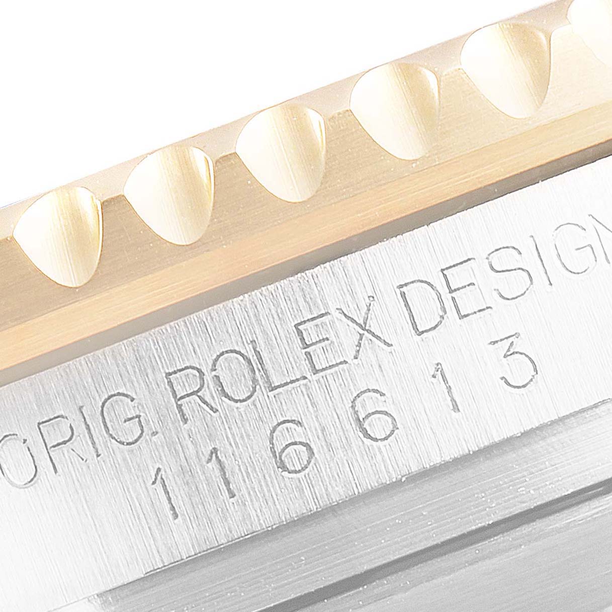 This close-up image of the Rolex Submariner 116613 Men's Steel and Gold (two tone) Blue Dial 116613 Men's Steel and Gold (two tone) Blue Dial shows part of the bezel and the "ROLEX DESIGN" inscription along with the model number.