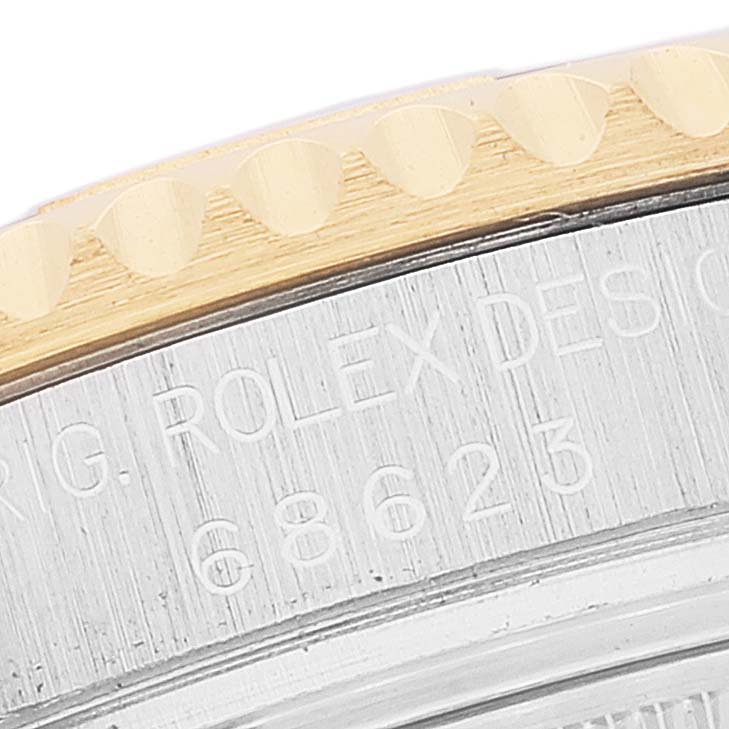 This close-up image shows the engraved bezel and part of the case of the Rolex Yacht-Master 68623 Men
s Steel and Gold (two tone) Blue Dial 68623 Men
s Steel and Gold (two tone) Blue Dial watch.