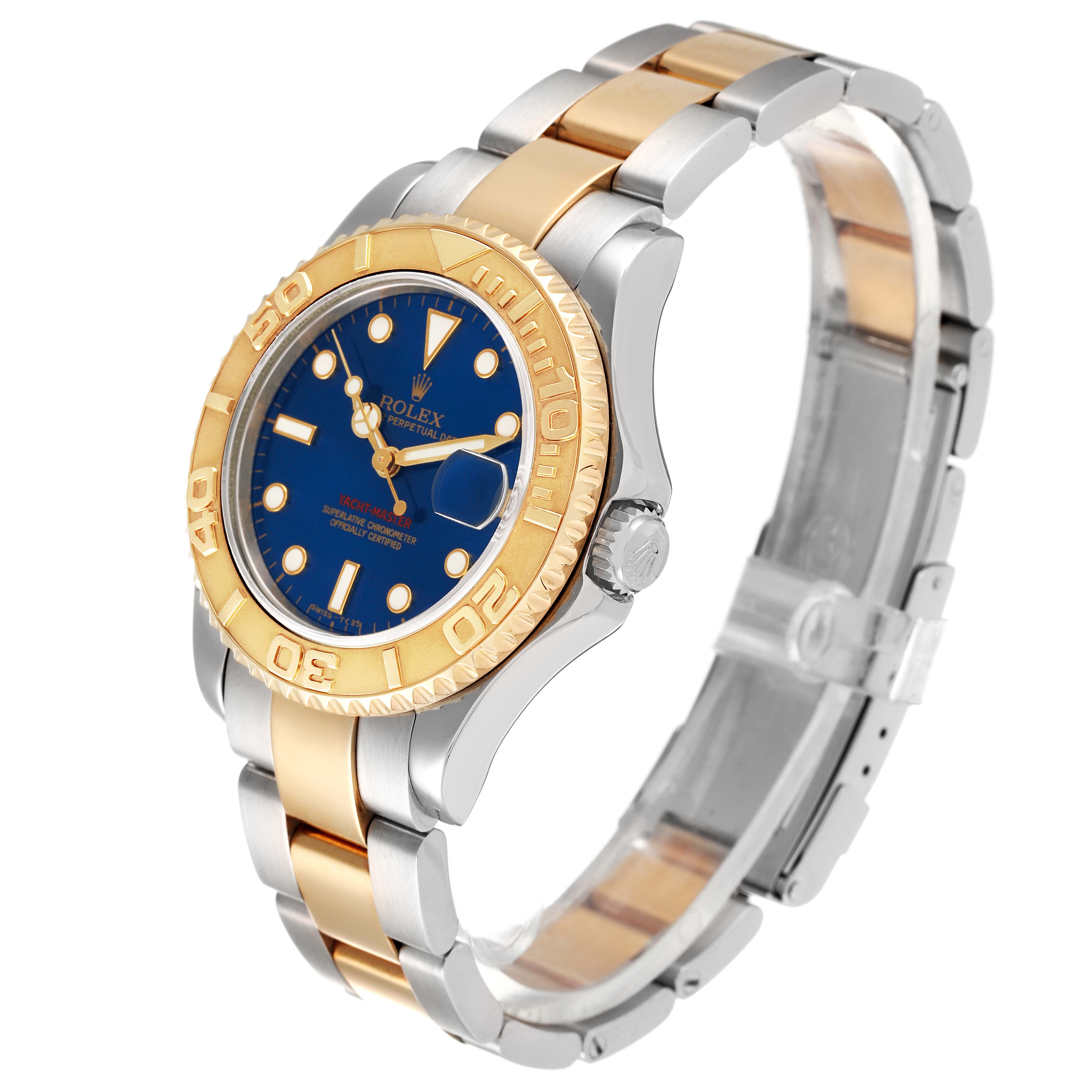The image shows a Rolex Yacht-Master 68623 Men
s Steel and Gold (two tone) Blue Dial 68623 Men
s Steel and Gold (two tone) Blue Dial watch at an angled side view, highlighting its blue dial, gold bezel, and two-tone bracelet.
