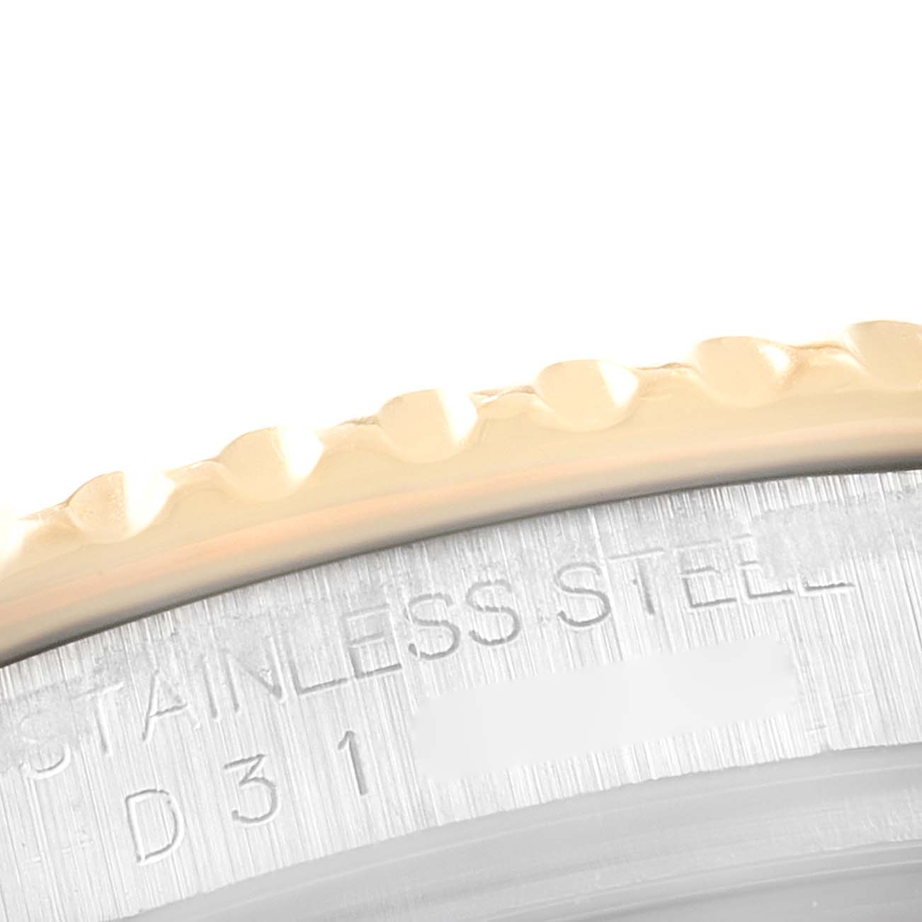 This close-up image of a Rolex Yacht-Master 16623 Men
s Steel and Gold (two tone) Champagne Dial 16623 Men
s Steel and Gold (two tone) Champagne Dial watch shows part of the bezel and case, highlighting the "STAINLESS STEEL" engraving.