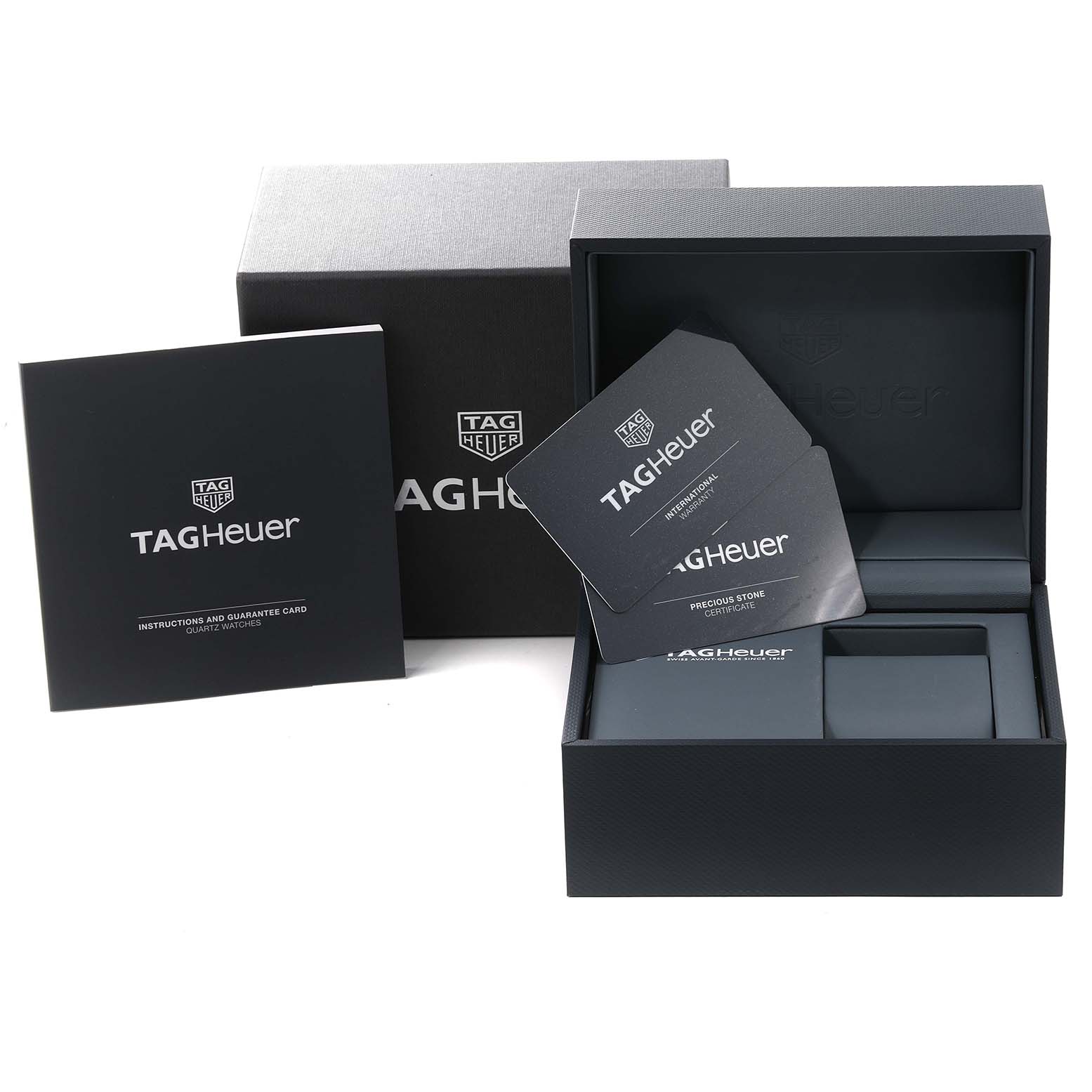 The image shows the packaging and accessories of a Tag Heuer Aquaracer WBD1415 Women's Stainless Steel Mother of Pearl Dial WBD1415 Women's Stainless Steel Mother of Pearl Dial watch, including the box, manual, and guarantee cards.
