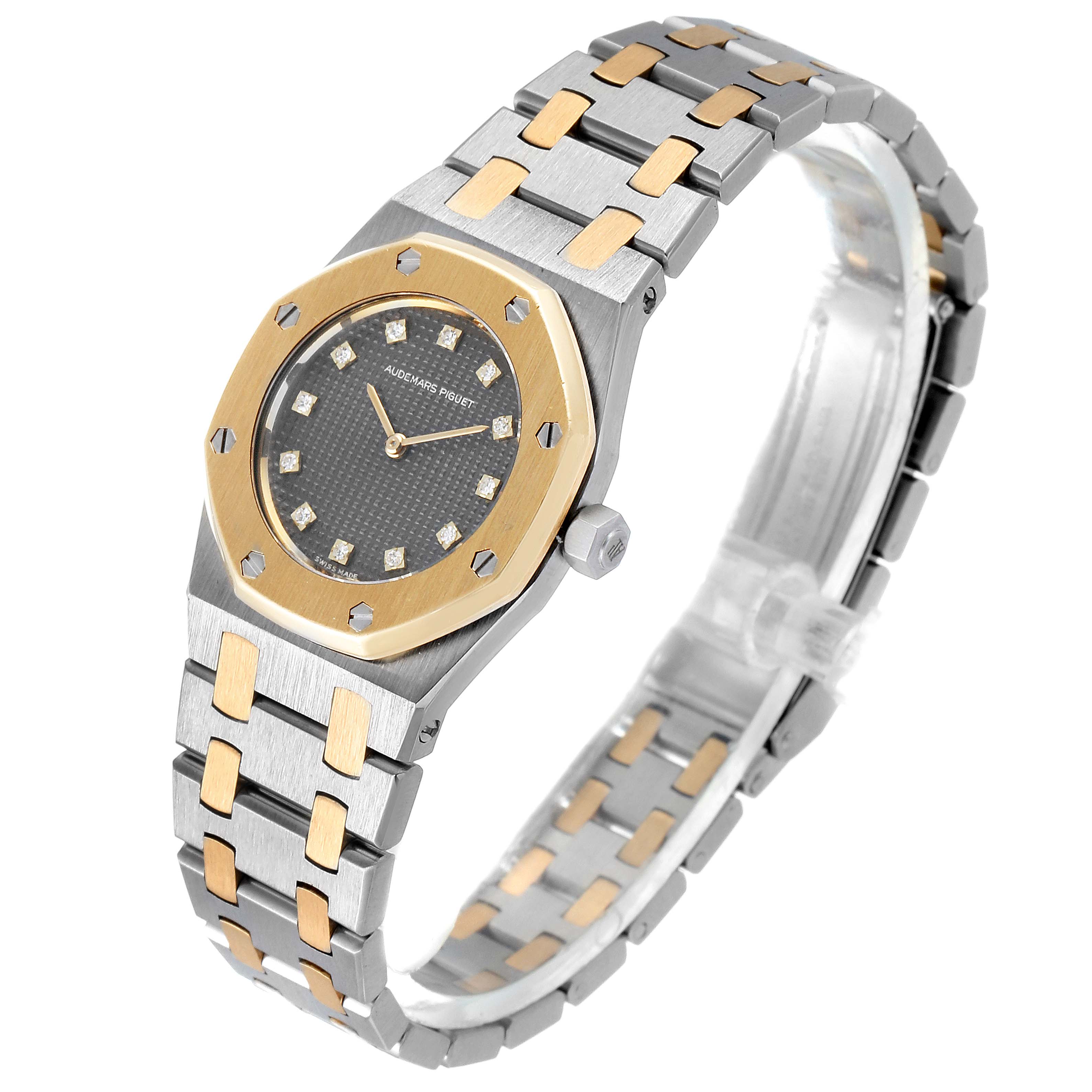 The image shows a side angle of an Audemars Piguet Royal Oak 6131-516 Women's Steel and Gold (two tone) Grey Dial 6131-516 Women's Steel and Gold (two tone) Grey Dial watch, highlighting its octagonal bezel, black face, and two-tone metal bracelet.
